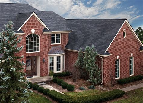 blue metal roof on red brick house|black shingles on brick house.